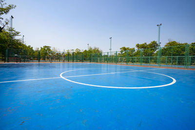 View of basketball hoop against blue sky