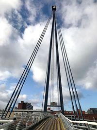 Low angle view of suspension bridge against sky