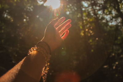 Midsection of woman against bright sun