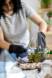 Midsection of woman planting plants