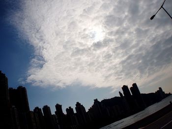 Low angle view of silhouette buildings against sky