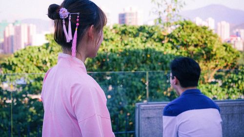 Rear view of people looking at city