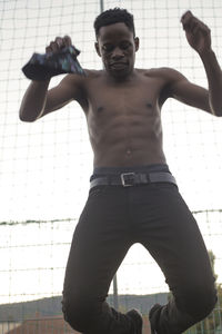 Rear view of man exercising in gym