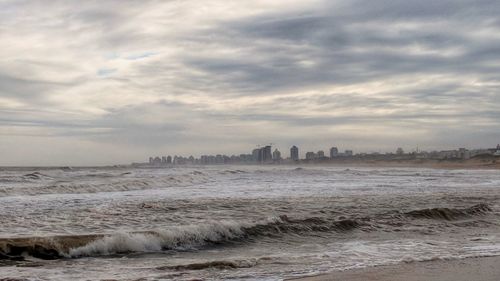 Scenic view of sea against sky in city