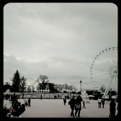 Ferris wheel against cloudy sky