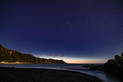 Scenic view of sea against sky at night