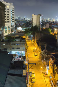 High angle view of illuminated buildings in city at night