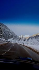 Road against sky seen through car windshield