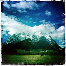 Scenic view of mountains against cloudy sky