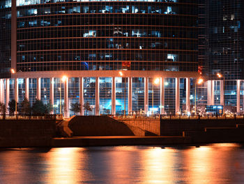 Reflection of illuminated building in water at night