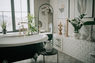 Luxury interior of big bathroom at modern african style with oval bathtub in natural lighting