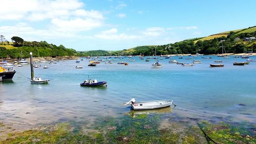 Boats moored in sea against sky