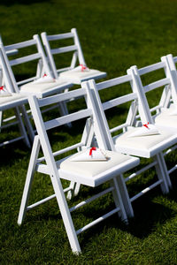 White chairs for a wedding ceremony on a green meadow