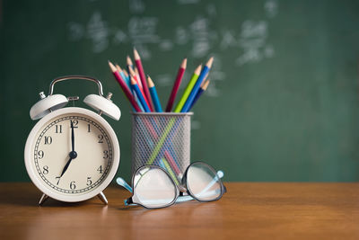 Close-up of clock on table