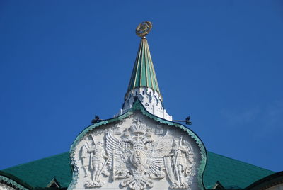 Low angle view of statue against clear blue sky