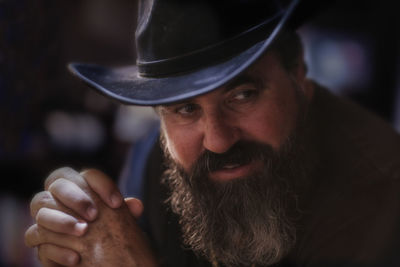 Close-up of bearded mature man wearing hat