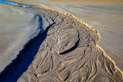 High angle view of footprints on sand