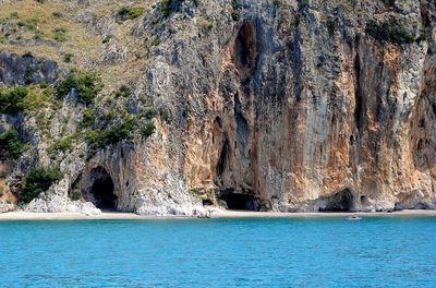 Scenic view of sea by rock formation