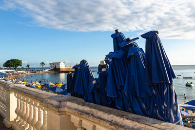 View of umbrellas and santa maria fort in the background on porto da barra beach 