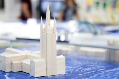 Close-up of cross on table against building