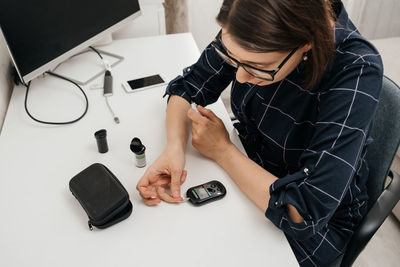 Midsection of woman using mobile phone