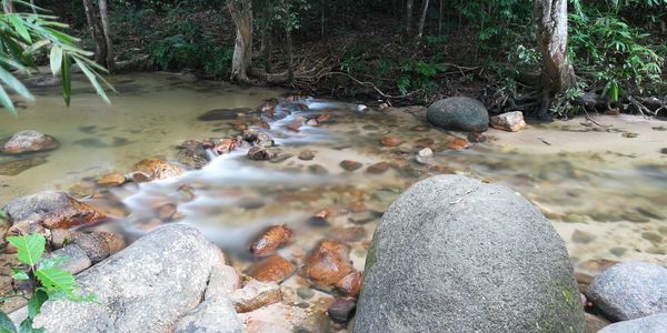 Pebbles on rocks in water