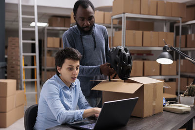 Side view of man using laptop at home