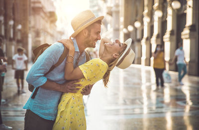 Smiling couple standing amidst alley