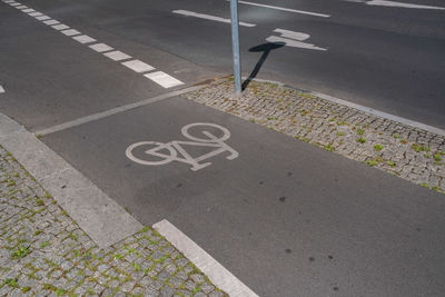 High angle view of arrow sign on road