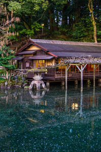 Building by lake against trees