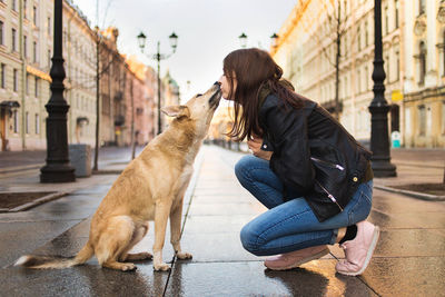 Man sitting on dog