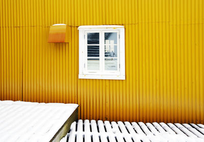 Open window of yellow house