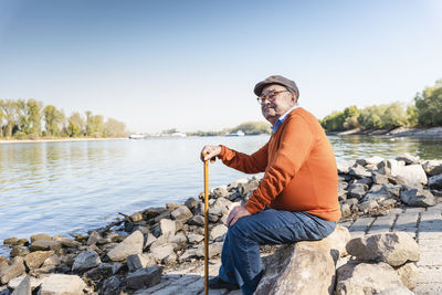 Old man sitting by the river