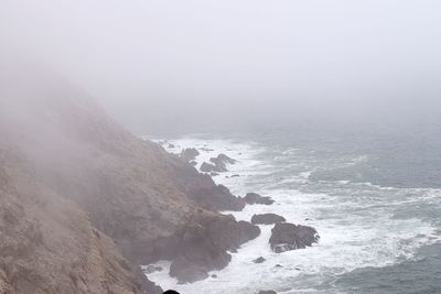 Scenic view of sea against sky during foggy weather