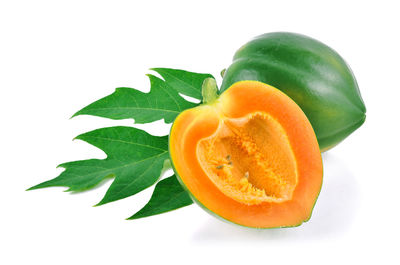 Close-up of orange fruit against white background