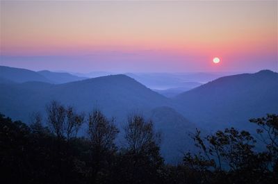 Scenic view of mountains against sky at sunset