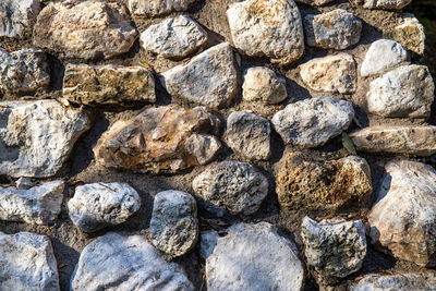 A portion of wall made of rough stones. texture to be used as a background.