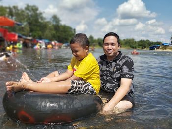 Boy sitting on boat in lake