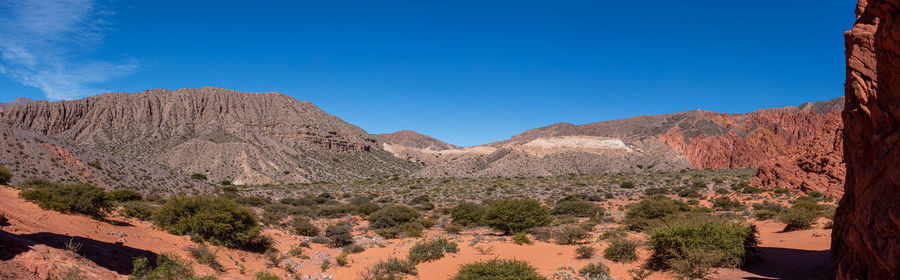 Scenic view of desert against blue sky