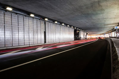 Empty road in illuminated tunnel