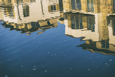 Reflection of buildings in swimming pool