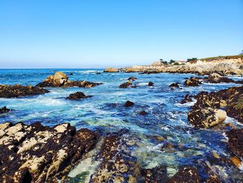 Scenic view of sea against clear blue sky