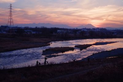 Scenic view of field against sky during sunset