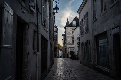 Narrow alley amidst buildings in city