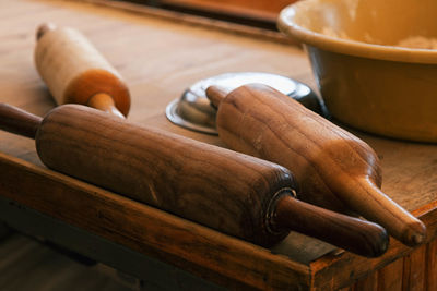 High angle view of rolling pins on table at bakery