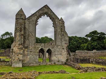 Old ruins of building against cloudy sky