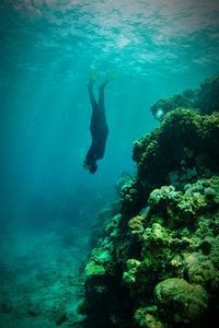 Full length of scuba diver swimming in sea