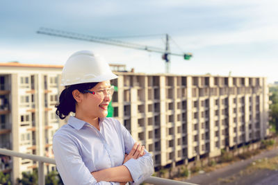 Female engineer looking away while standing at construction site