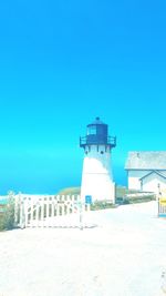 Lifeguard hut on beach against clear blue sky