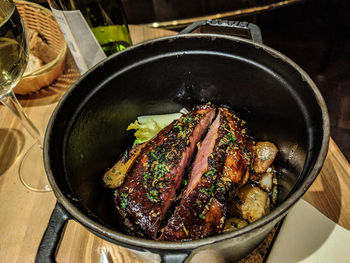 Meat in utensil on table